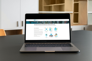 Laptop showing the Data Protection Education Knowledge Bank Home screen on a desk