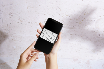 Image of a hand holding a phone with a white keyboard and the word 'Access'